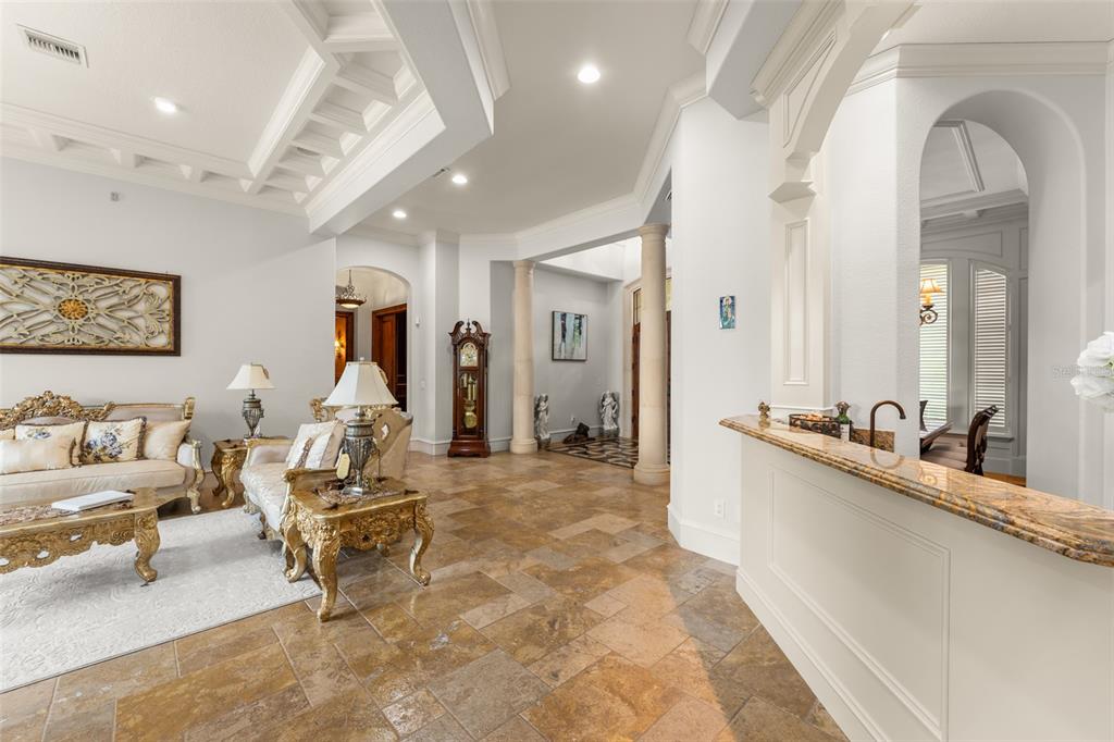 A living room with tile floors, ornate gold furniture, and a tray ceiling — 6055 LOUISE COVE DRIVE, WINDERMERE, FL