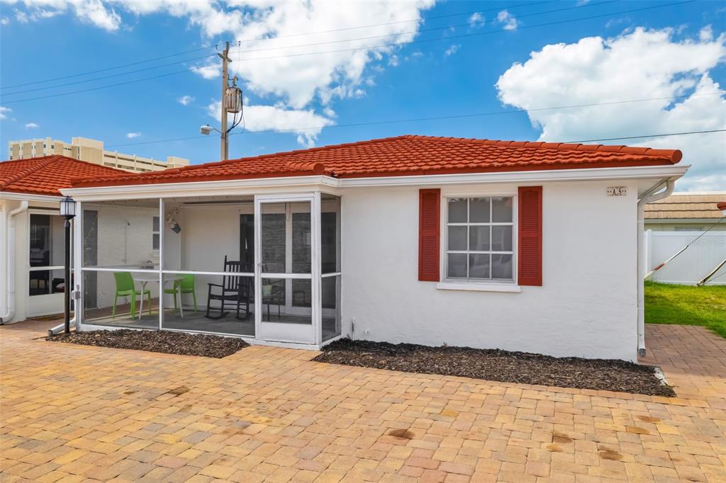 A white single-story building with a red tile roof and a screened-in patio area — 6154 MIDNIGHT PASS ROAD UNIT A-3, SARASOTA, FL