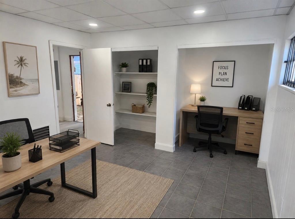 An office space with two desks, a built-in shelving unit, and gray tile flooring — 1780 E DUVAL STREET UNIT 6, LAKE CITY, FL