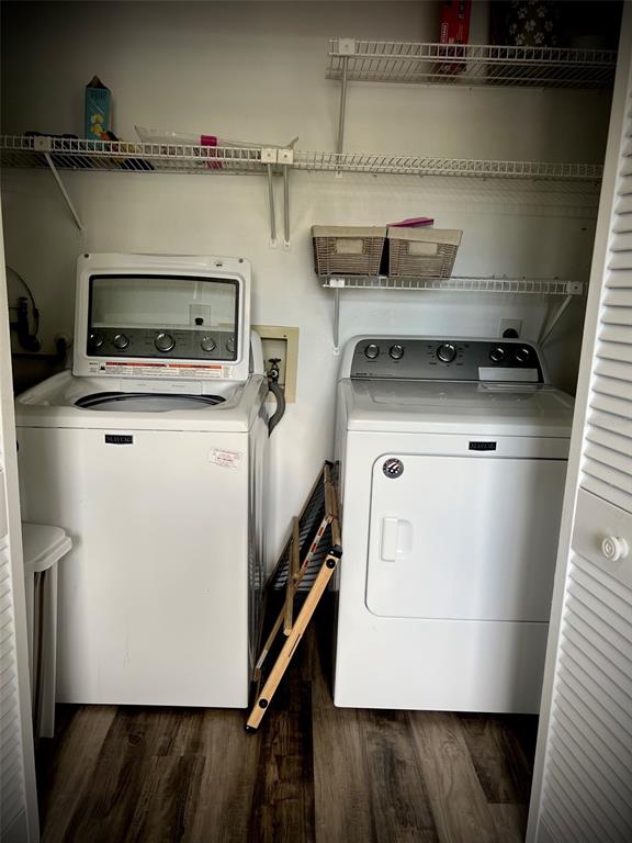 A laundry closet contains a white top-loading washing machine, a dryer, and wire shelving — 5110 MARSH FIELD ROAD UNIT 68, SARASOTA, FL