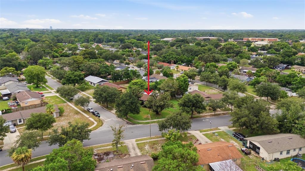 An aerial view shows a residential neighborhood with a red arrow pointing to a house — 530 E FOOTHILL WAY, CASSELBERRY, FL