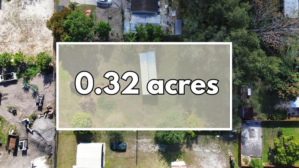An aerial view shows a rectangular plot of land with a small structure and trees — 9560 HOENSTINE AVENUE, ORLANDO, FL