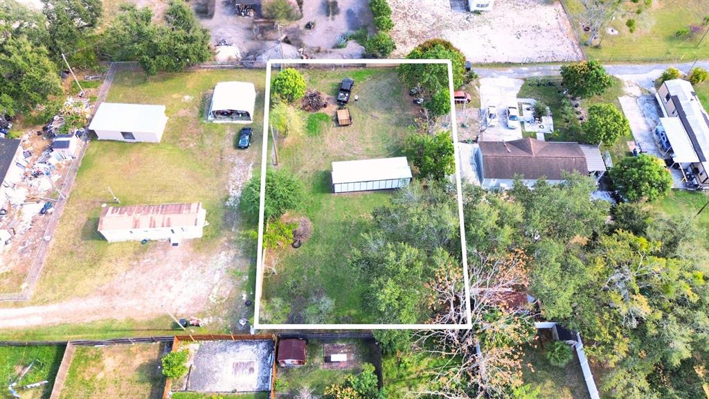 An aerial view shows a rectangular lot containing a long, narrow building and trees — 9560 HOENSTINE AVENUE, ORLANDO, FL