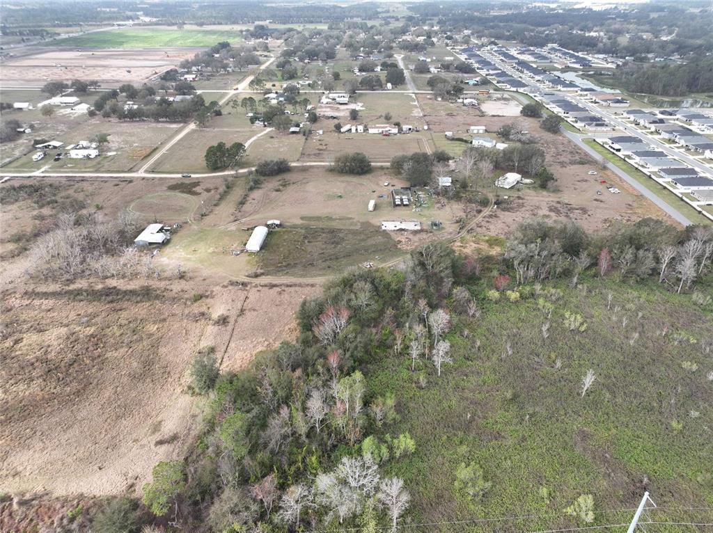 An aerial view shows a rural property with several small buildings surrounded by open land — 307 & 317 SKYBLUE LANE, AUBURNDALE, FL