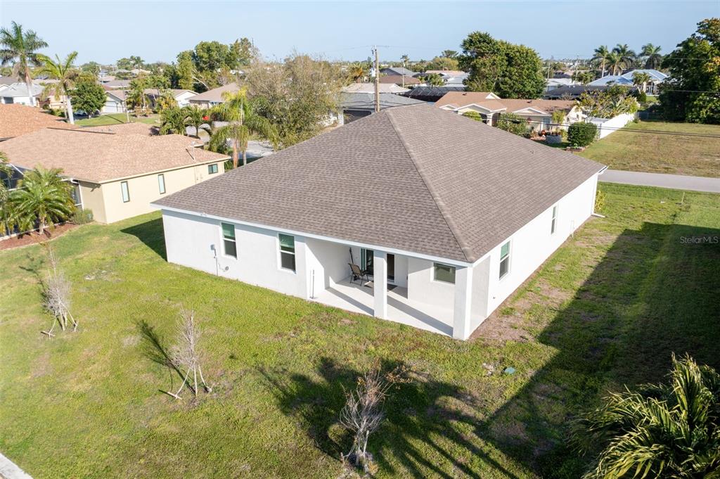 An aerial view of the back of a white house with a covered patio — 1452 SE 13TH TERRACE, CAPE CORAL, FL