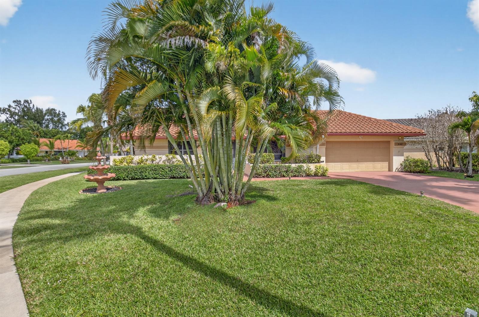 A single-story house with a tile roof, a palm tree, and a fountain in front — 9362 Laurel Green Drive, Boynton Beach FL 33437, BOYNTON BEACH, FL