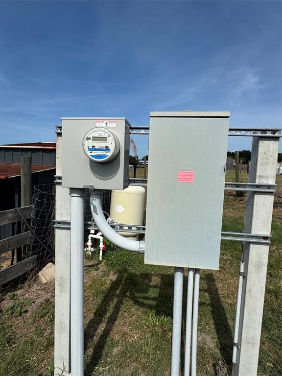 An outdoor electrical meter and disconnect box mounted on a metal frame in a yard — 807 CAMPBELL LANE, DE LEON SPRINGS, FL