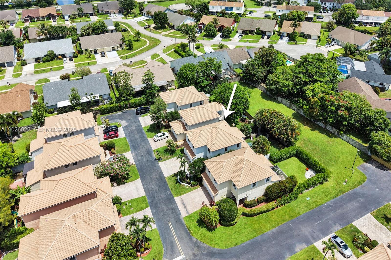 An aerial view shows a cluster of suburban houses with tile roofs and paved driveways — 11953 Donlin Dr, Wellington FL 33414, WELLINGTON, FL