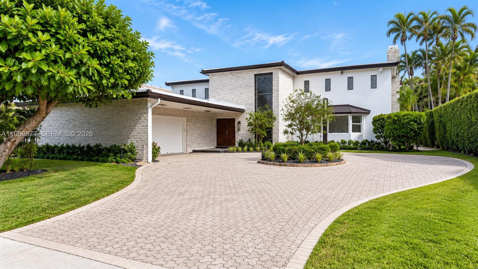 A two-story house with a white brick facade, a circular driveway, and a large tree — 4403 Palm Ln, Miami FL 33137, MIAMI, FL