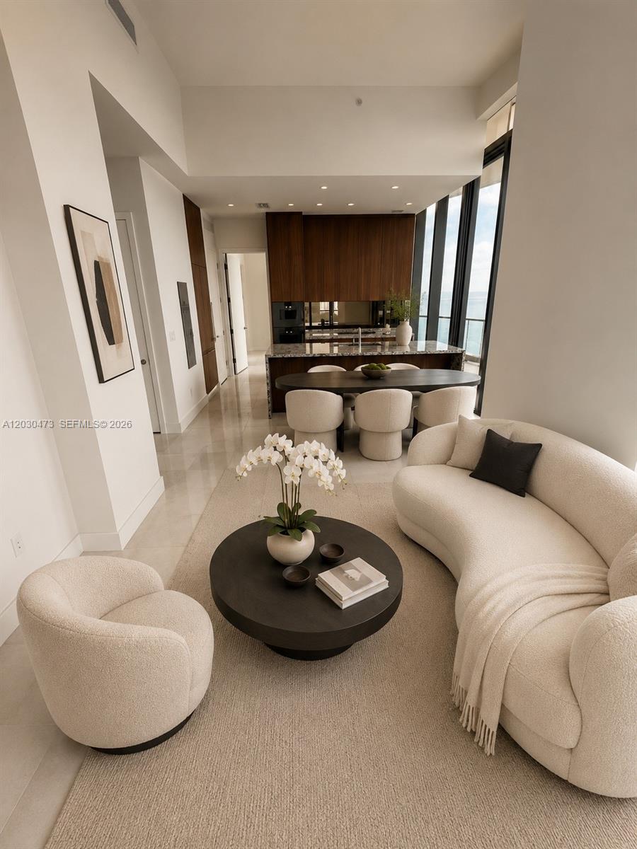 A modern living and dining area features cream-colored curved furniture, a dark table, and floor-to-ceiling windows — 175 SE 25th rd # 1503, Miami FL 33129, MIAMI, FL
