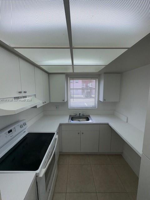 A kitchen with white cabinets, white countertops, a black stove, and a window above the sink — 7500 SW 82nd St # G110, Miami FL 33143, MIAMI, FL