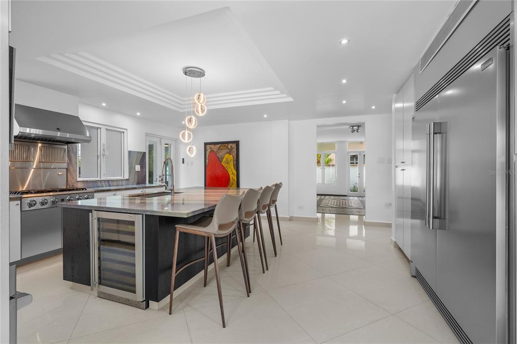 A living room features a large white sectional sofa, a wooden coffee table, and tile flooring — 18 PASEO LAS PALMAS, DORADO, PR, PR