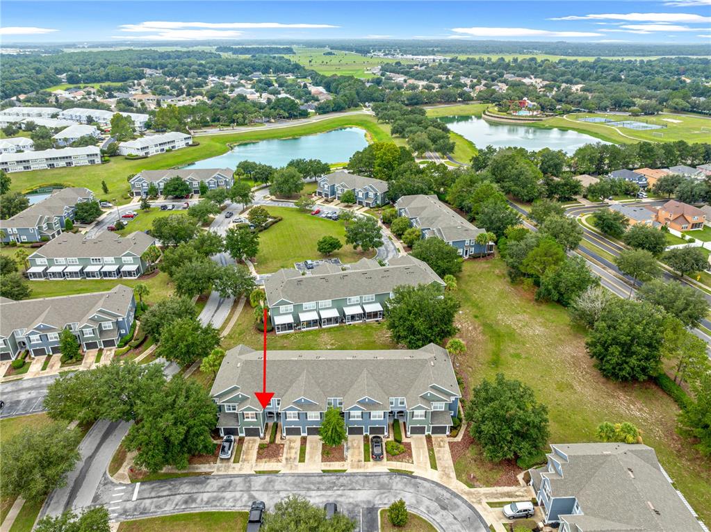 An aerial view shows a multi-unit townhouse complex with a red arrow pointing to one unit — 4131 SW 51ST CIRCLE, OCALA, FL