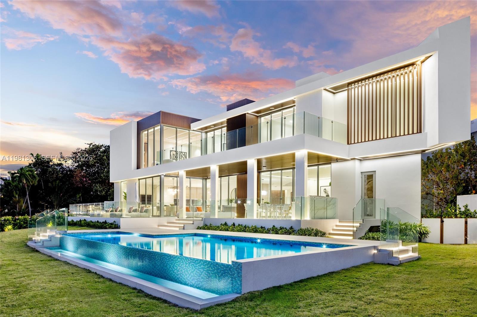 A modern two-story white house features a large infinity pool and glass balcony railings — 503 Palm Dr, Hallandale Beach FL 33009, HALLANDALE BEACH, FL