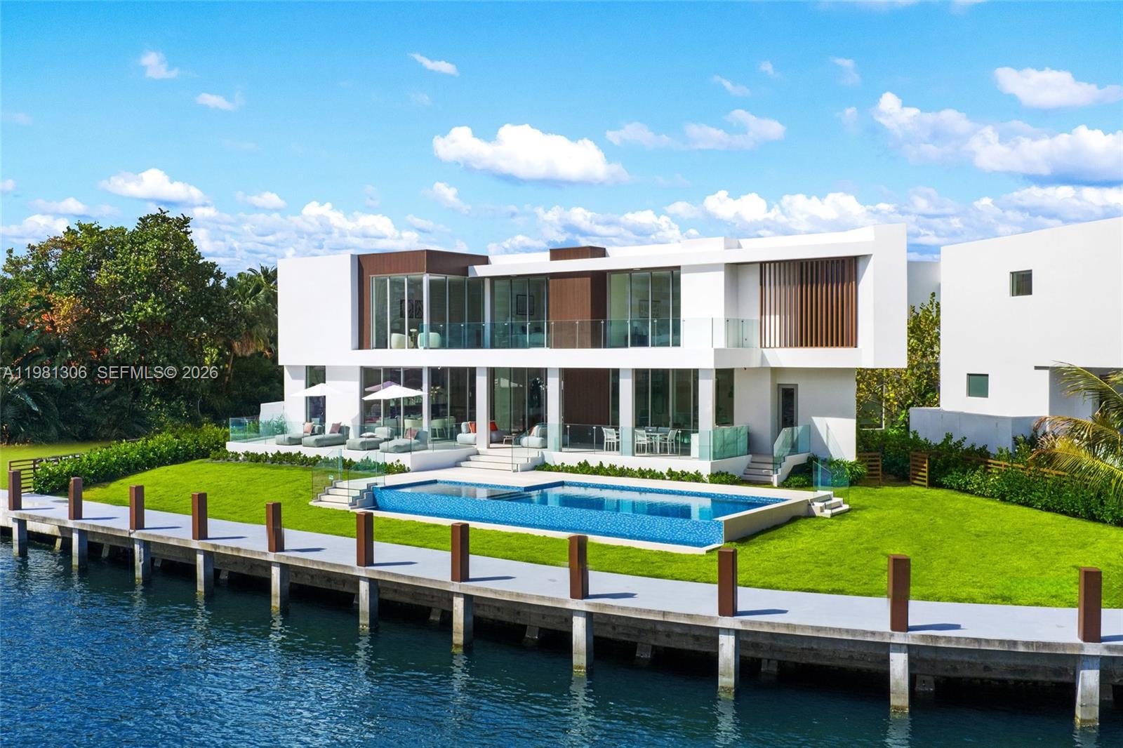 A modern two-story white house features a swimming pool and a dock on the water — 503 Palm Dr, Hallandale Beach FL 33009, HALLANDALE BEACH, FL