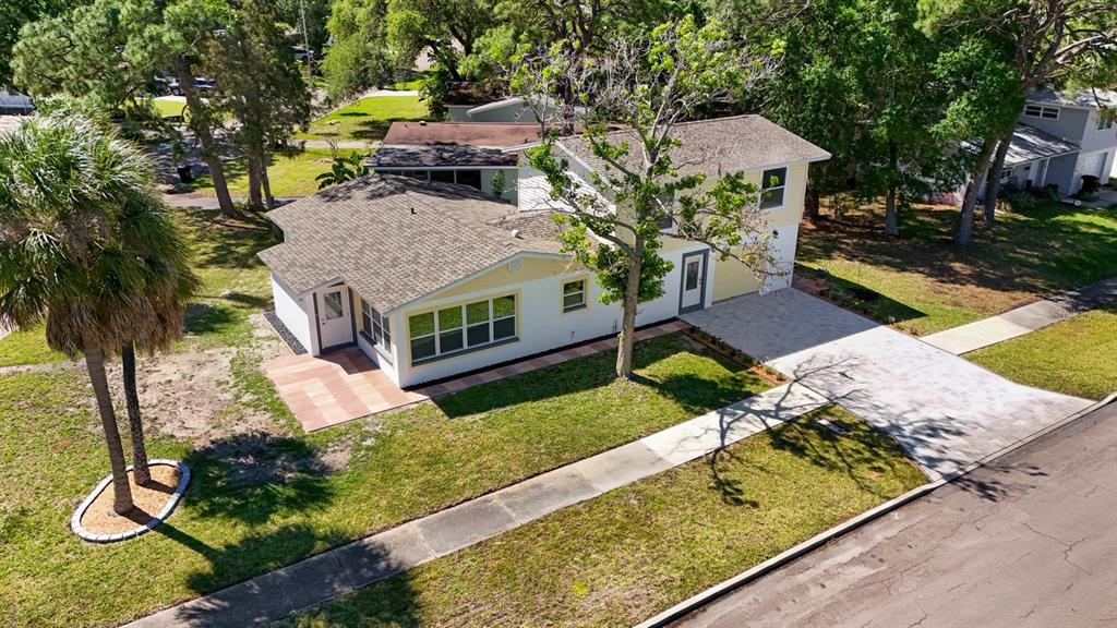 An aerial view of a two-story house with a paved driveway and a palm tree — 4038 HARRISBURG, ST PETERSBURG, FL