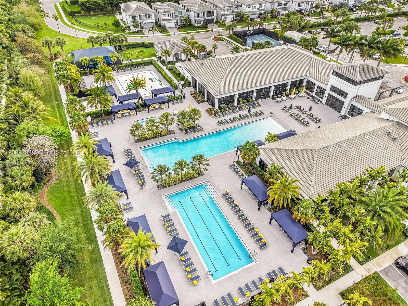 An aerial view shows a community clubhouse with two swimming pools and lounge seating areas — 17197 Teton River Rd # 0, Boca Raton FL 33496, BOCA RATON, FL