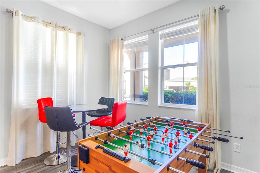 A game room features a foosball table, a small round table, and four chairs — 436 ALDRIDGE LANE, DAVENPORT, FL