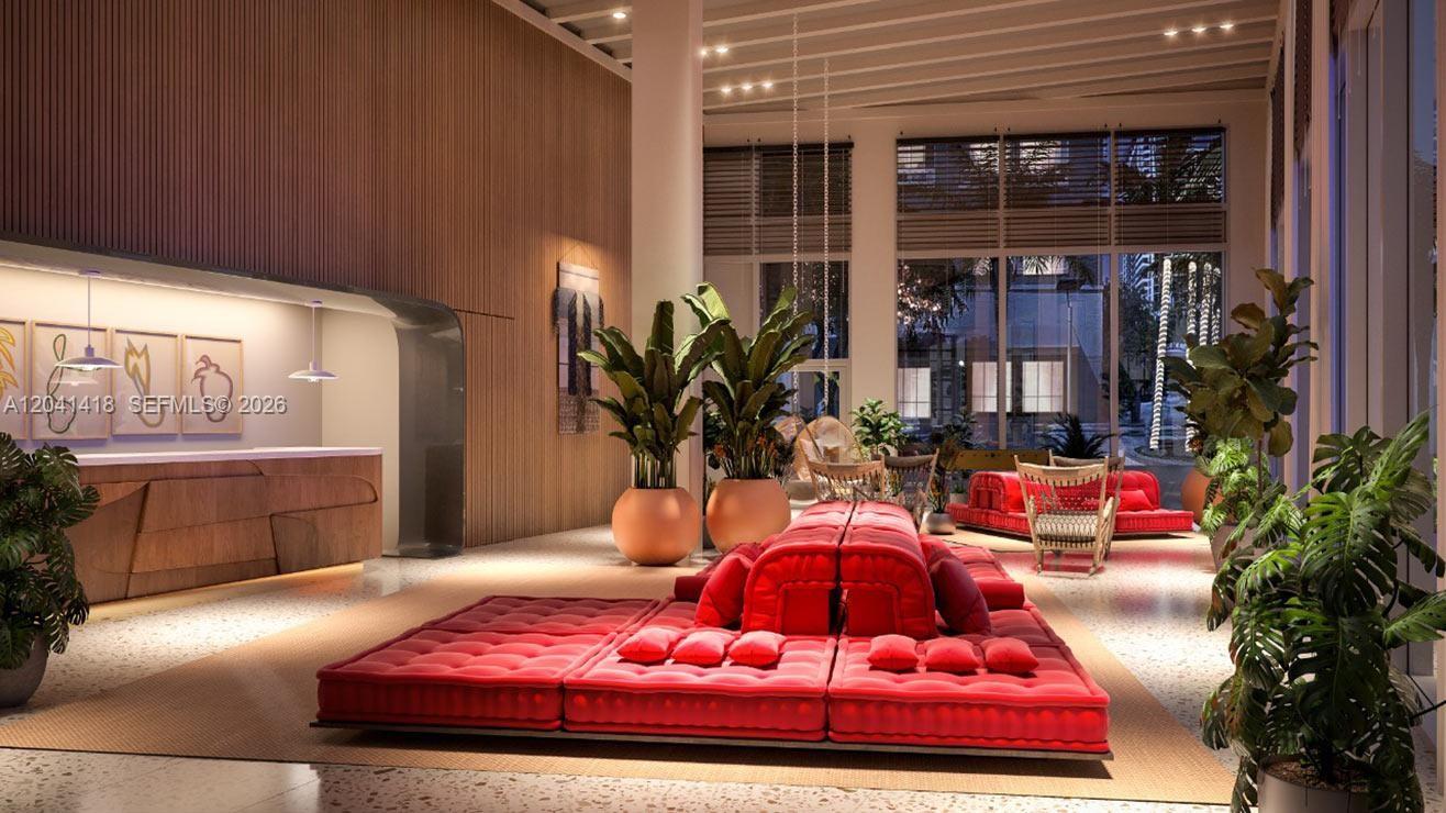 This rendering shows a modern lobby with a red modular sofa and large potted plants — 90 NE 32nd St # 707, Miami FL 33137, MIAMI, FL