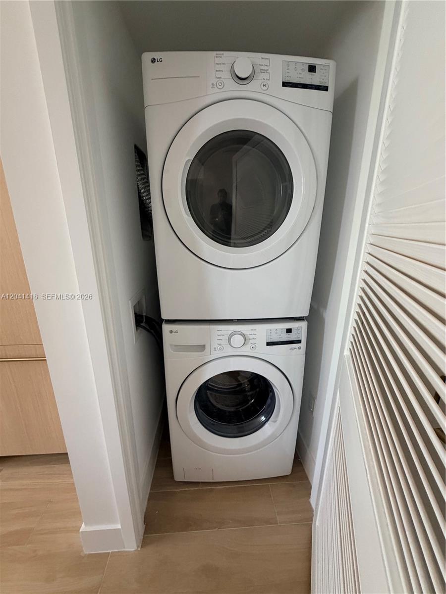 A white LG stacked washer and dryer unit is installed in a small laundry closet — 90 NE 32nd St # 707, Miami FL 33137, MIAMI, FL