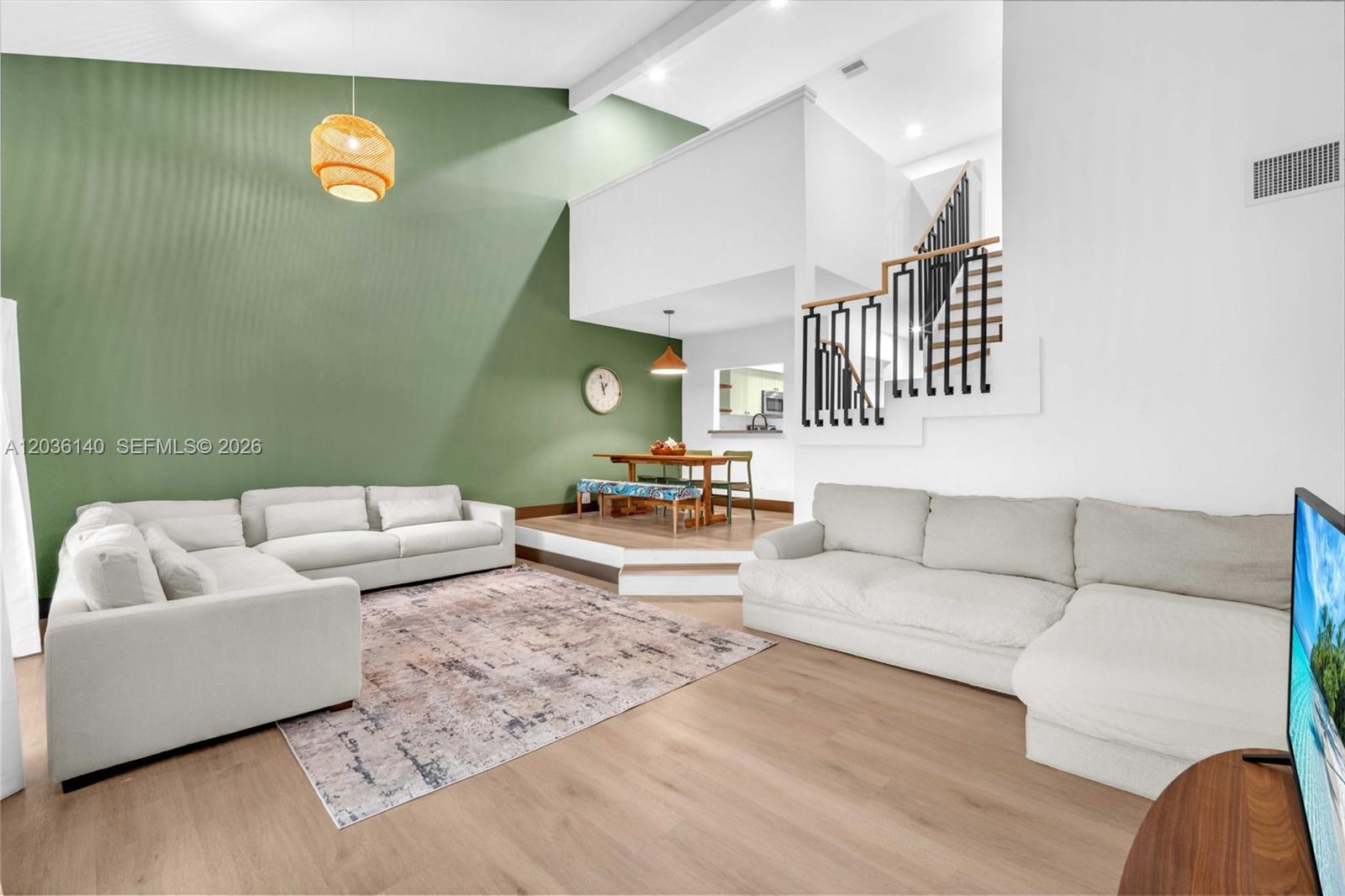 A living room features a vaulted ceiling, green accent wall, and a raised dining area — 4171 SW 85th Ave, Davie FL 33328, DAVIE, FL