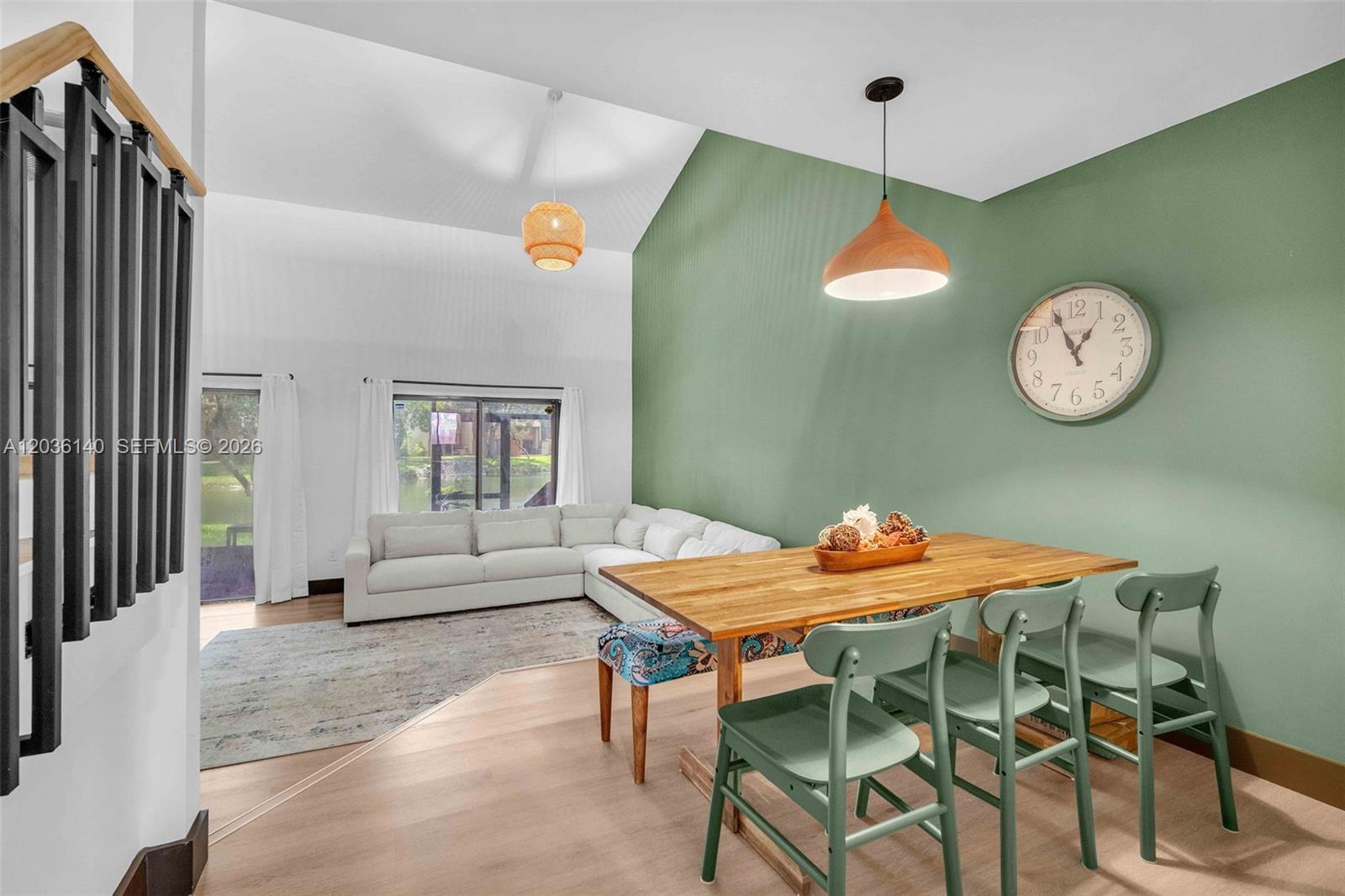 A dining area with a wooden table and green chairs sits before a green accent wall — 4171 SW 85th Ave, Davie FL 33328, DAVIE, FL
