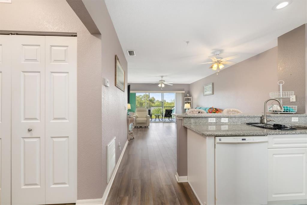 A view from a kitchen looking toward a living area with a balcony beyond — 19385 WATER OAK DRIVE UNIT 304, PORT CHARLOTTE, FL