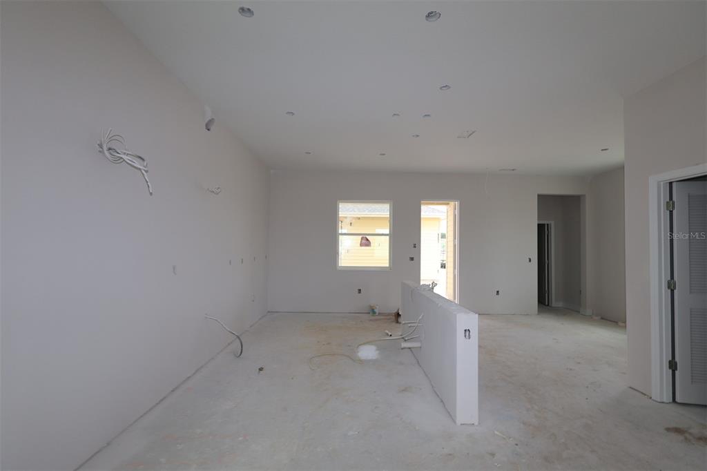 An unfinished room features light-colored walls, recessed lighting, and a central kitchen island partition — 6721 RUCKSACK ROAD, ST CLOUD, FL