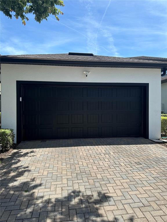 A living room with a gray sectional sofa, coffee table, and adjacent dining area — 7190 ENCHANTED LAKE DRIVE, WINTER GARDEN, FL