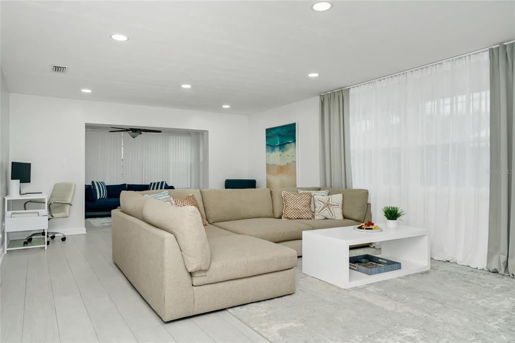 A living room features a beige sectional sofa, a white coffee table, and a desk area — 363 HARBOR DR, CAPE CANAVERAL, FL