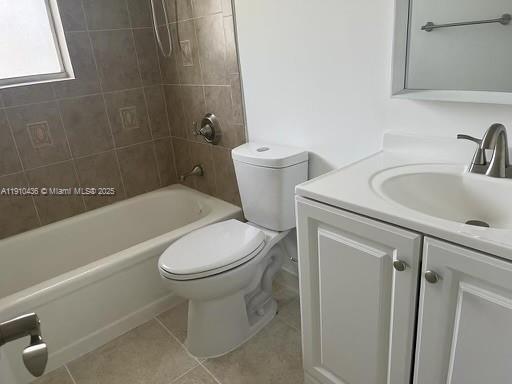 A bathroom features a white vanity, a toilet, and a bathtub with tiled walls — 540 SE 2nd Ave # J3, Deerfield Beach FL 33441, DEERFIELD BEACH, FL