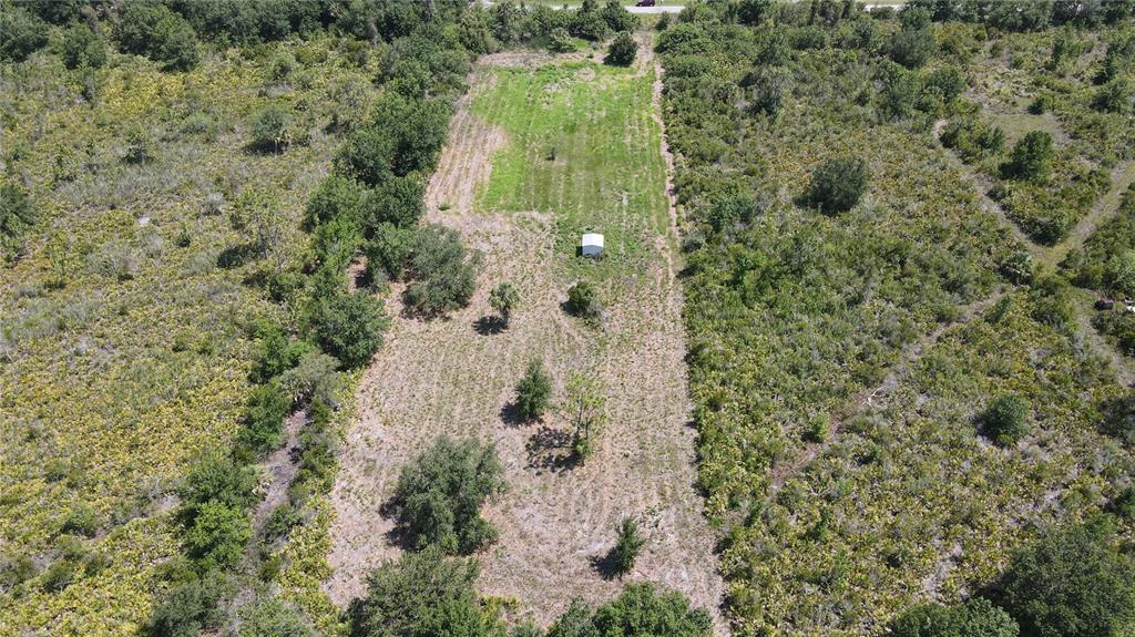 An aerial view shows a rectangular, partially cleared lot with a small shed — 29455 PINE VILLA CIRCLE, PUNTA GORDA, FL