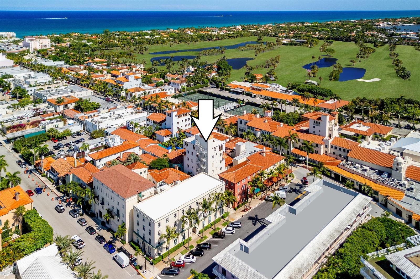 An aerial view of a multi-story building with a white facade and red tile roof — 9 Via Parigi, Palm Beach FL 33480, PALM BEACH, FL