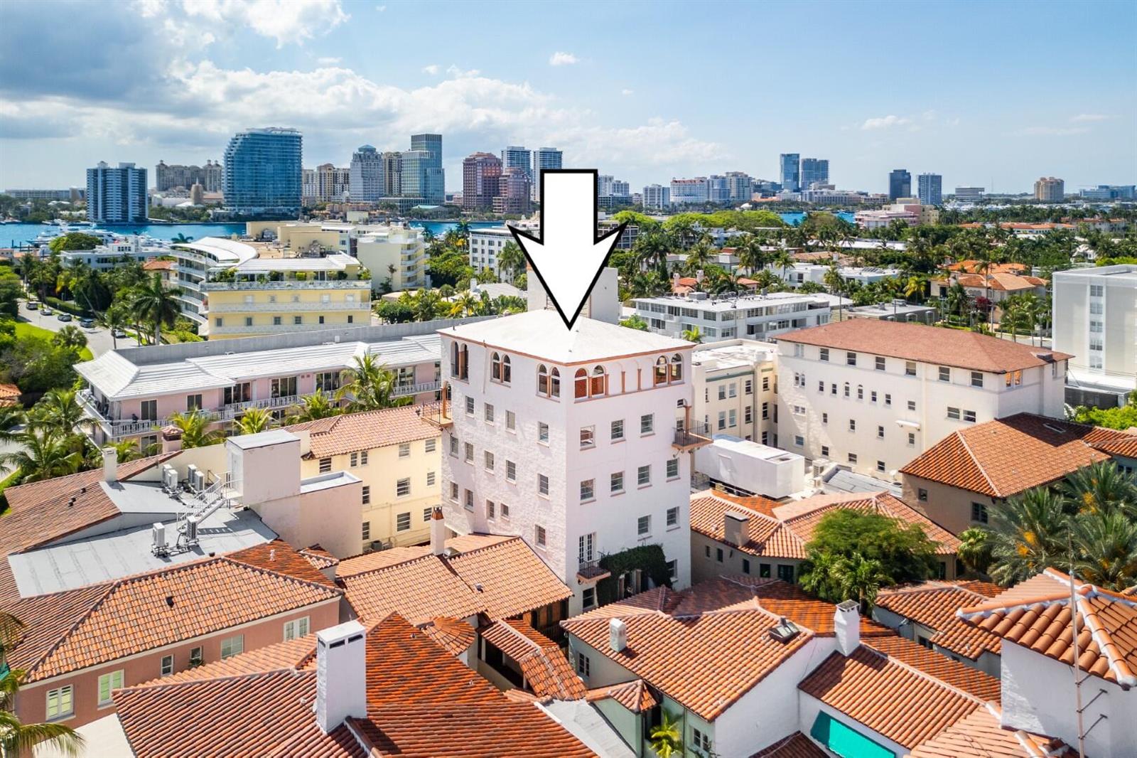 An aerial view shows a tall, white, multi-story building surrounded by lower structures with terracotta roofs — 9 Via Parigi, Palm Beach FL 33480, PALM BEACH, FL