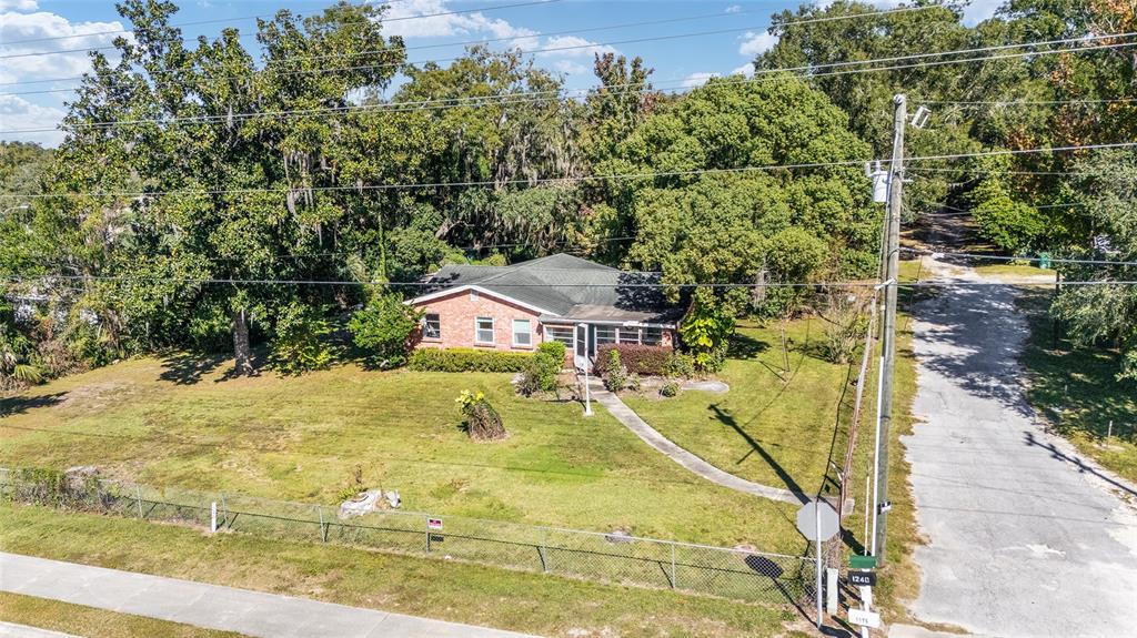 An aerial view shows a single-story brick house with a lawn and surrounding trees — 5985 W GULF TO LAKE HIGHWAY, CRYSTAL RIVER, FL