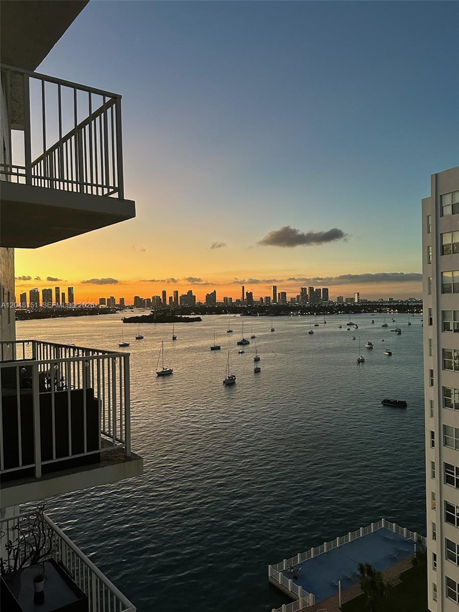 A high-angle view of a bay filled with sailboats at sunset from a balcony — 1228 West Ave # 1104, Miami Beach FL 33139, MIAMI BEACH, FL