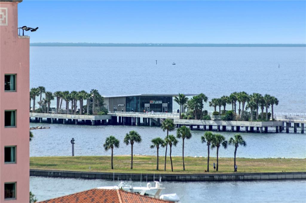 An elevated view shows a pier with a modern building extending into a large bay — 700 BEACH DRIVE NE UNIT 603, ST PETERSBURG, FL