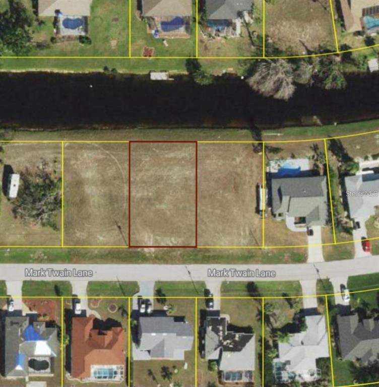 This aerial view shows a vacant, rectangular residential lot situated along a canal — 120 MARK TWAIN LANE, ROTONDA WEST, FL