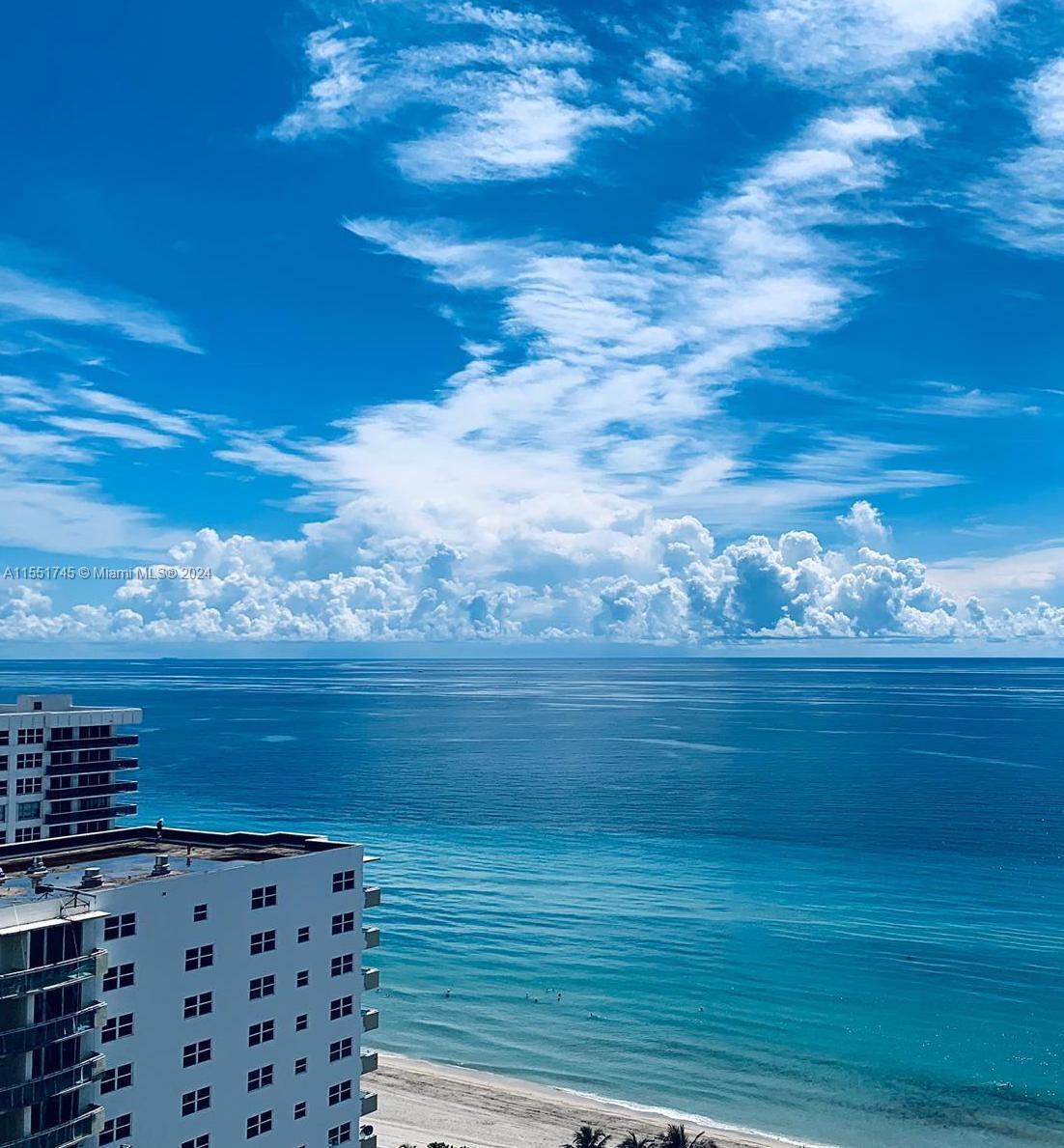 An elevated view of a beach, ocean, and sky from a high-rise balcony — 3101 S OCEAN DR # 2003, Hollywood FL 33019, HOLLYWOOD, FL
