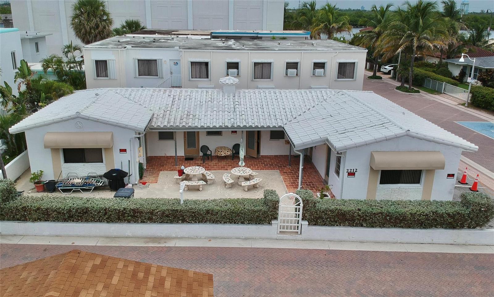 An aerial view shows a white, single-story building with a tiled roof and a patio — 2212 N Surf Road, Hollywood FL 33019, HOLLYWOOD, FL