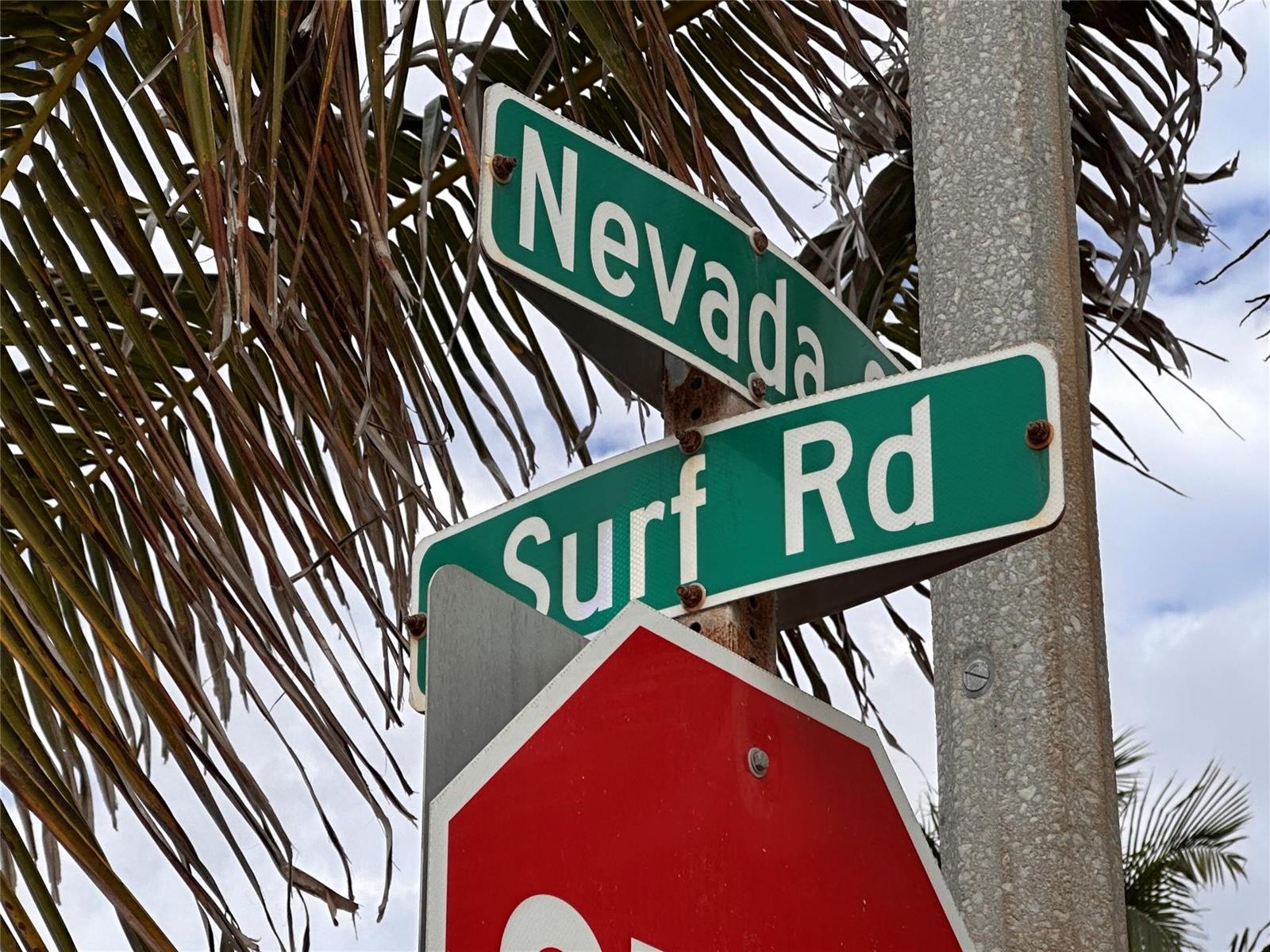 A street sign intersection for Nevada and Surf Rd stands next to a stop sign — 2212 N Surf Road, Hollywood FL 33019, HOLLYWOOD, FL