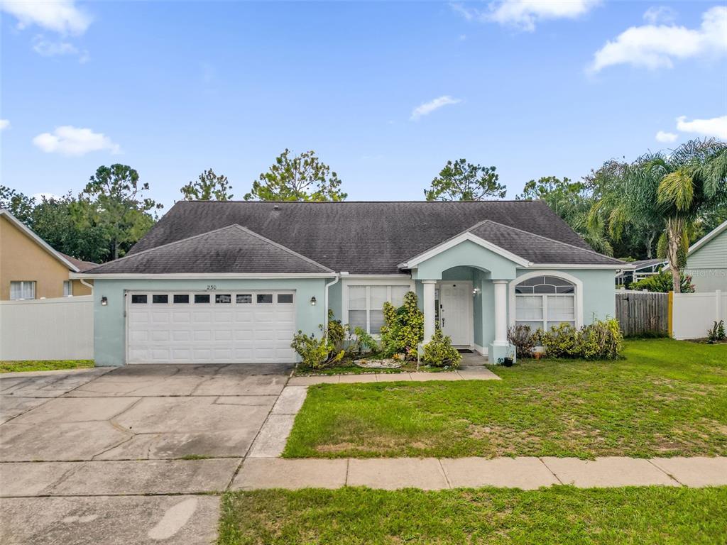 A single-story light blue house with a two-car garage and a covered front entryway — 230 LYTTON CIRCLE, ORLANDO, FL