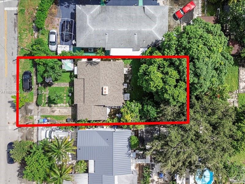 An aerial view shows a house with a brown roof surrounded by trees and landscaping — 1810 NW 16th Ter, Miami FL 33125, MIAMI, FL