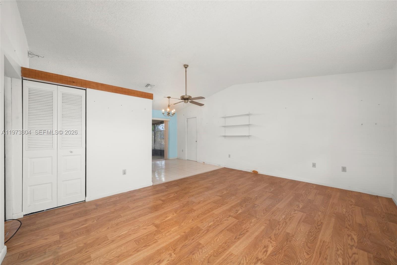 An empty room with wood-look flooring, white walls, a ceiling fan, and a closet — 2067 N Terrapin Road, Avon Park FL 33825, AVON PARK, FL