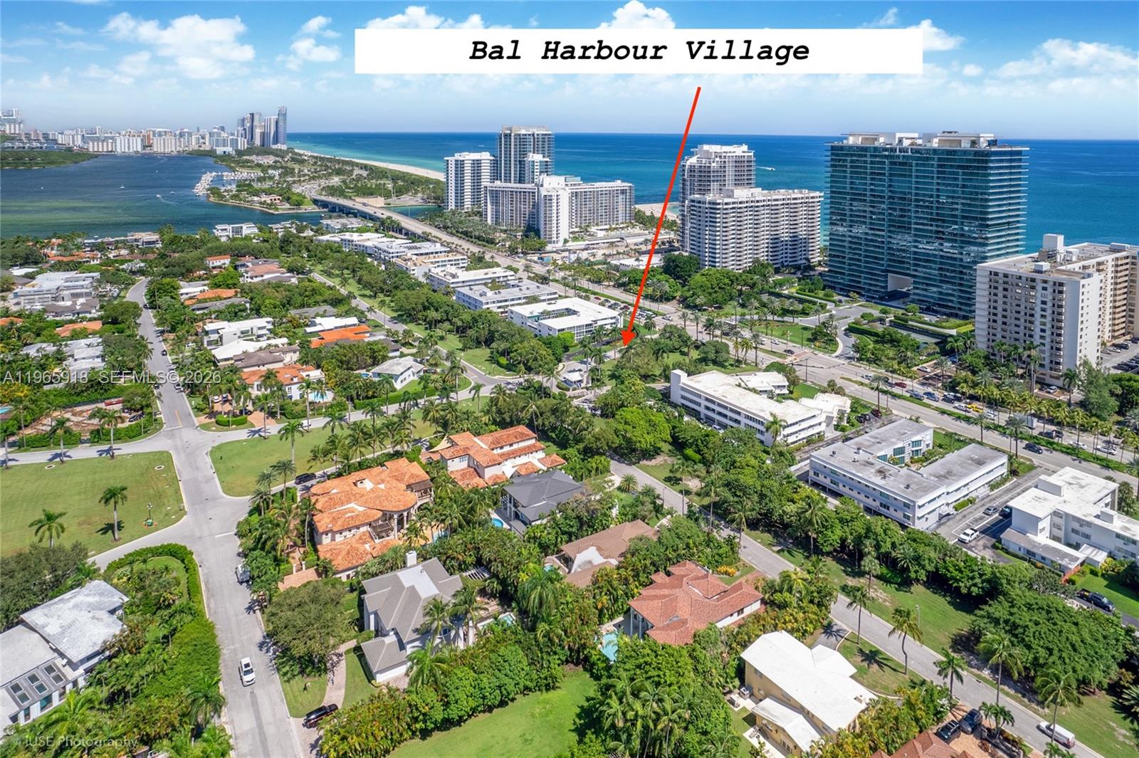 A white single-story house with a large paved driveway and palm trees in the yard — 52 Camden Dr, Bal Harbour FL 33154, BAL HARBOUR, FL