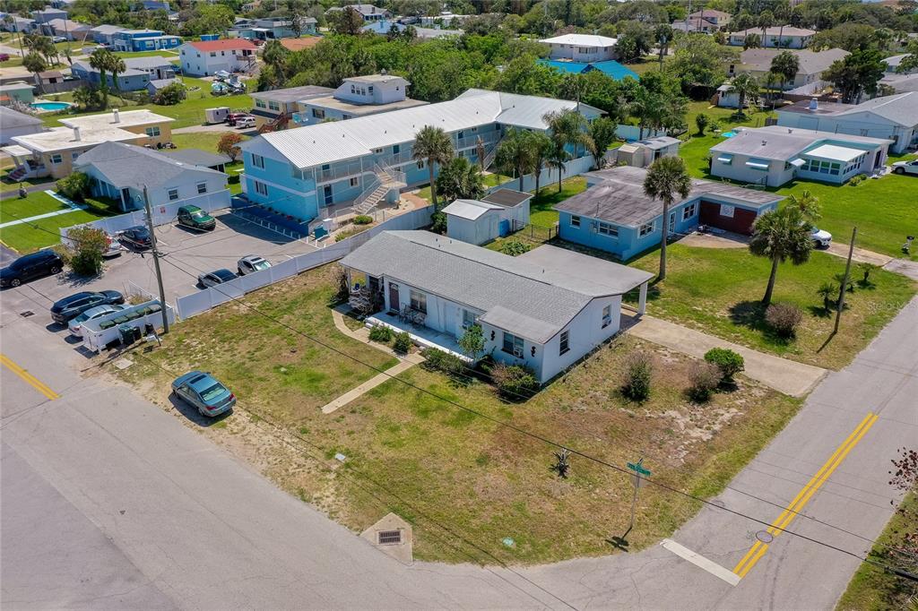 An aerial view shows a single-story house, a multi-unit apartment building, and surrounding residential properties — 130 BOYNTON BOULEVARD, DAYTONA BEACH, FL