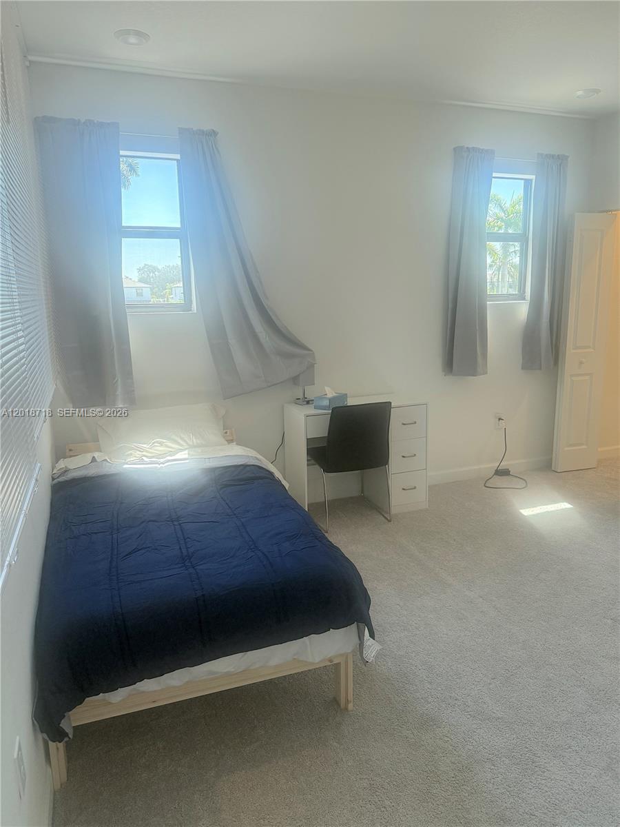 A bedroom features a twin bed, a white desk with a chair, and two windows — 4941 Oakmont Dr # 5838, Dania Beach FL 33312, DANIA BEACH, FL