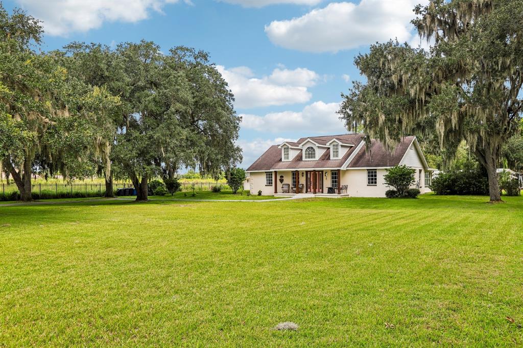 A two-story house with a large front lawn and mature trees draped in Spanish moss — 408 HOLLOWAY ROAD, PLANT CITY, FL