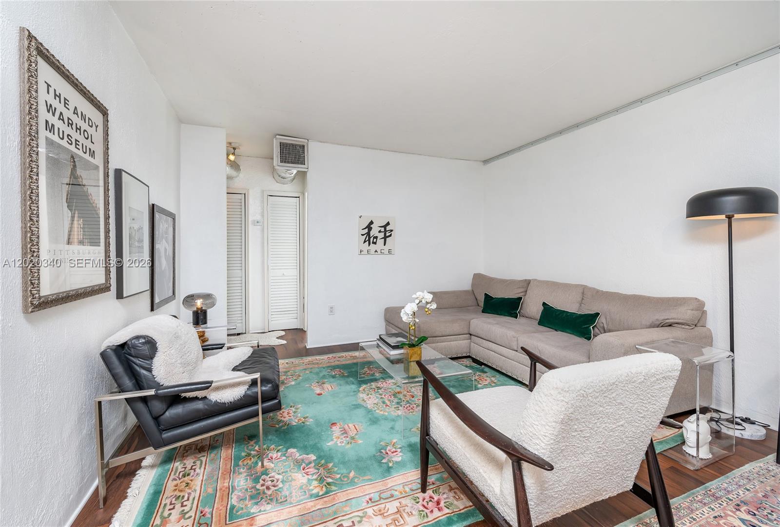 A living room features a sectional sofa, two accent chairs, and a large patterned rug — 1420 Pennsylvania Ave # 201, Miami Beach FL 33139, MIAMI BEACH, FL