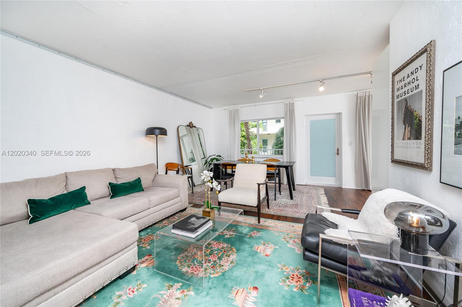 A living and dining room features a sectional sofa, area rugs, and modern furniture — 1420 Pennsylvania Ave # 201, Miami Beach FL 33139, MIAMI BEACH, FL